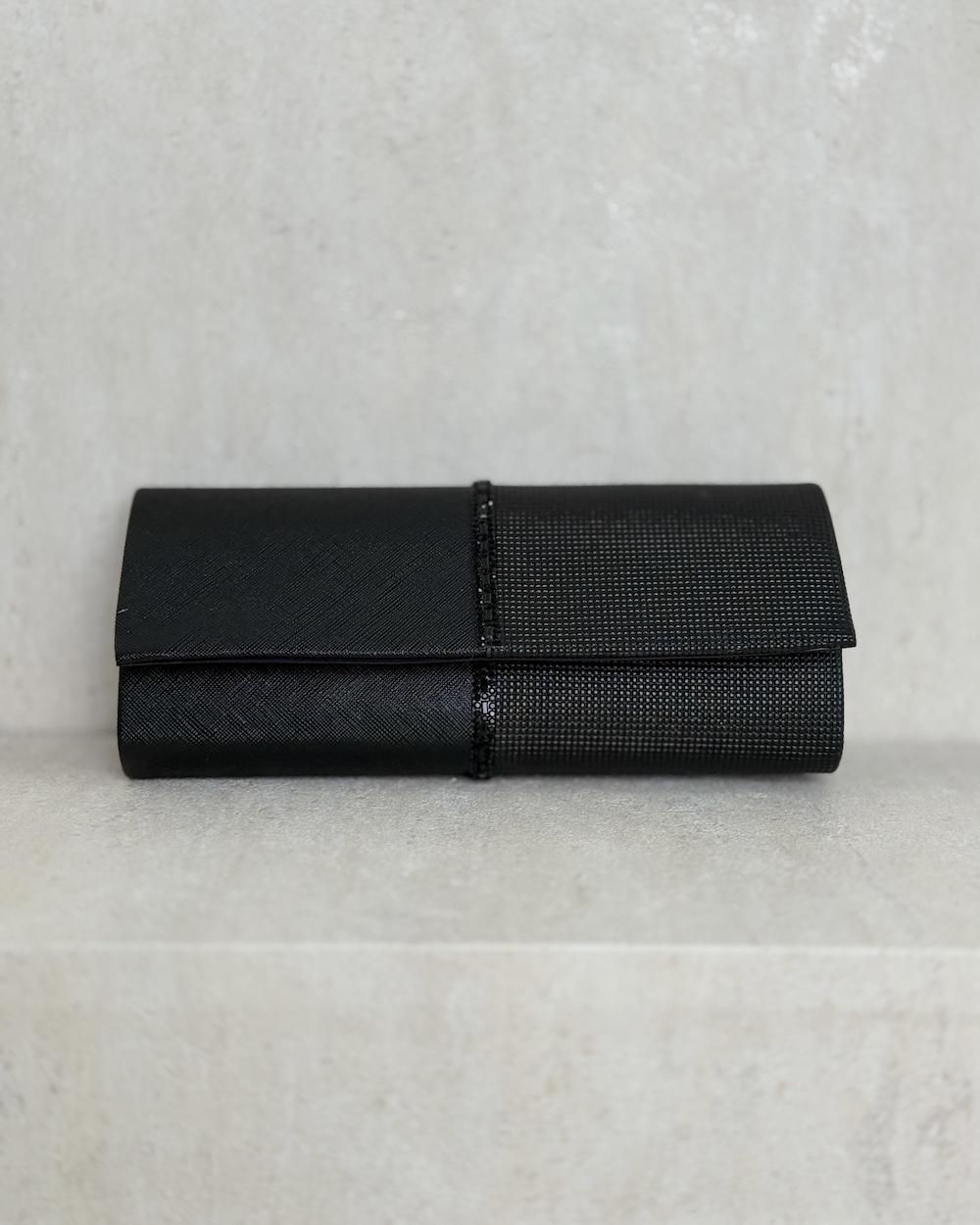 Evening bag decorated with a studded ribbon in the middle