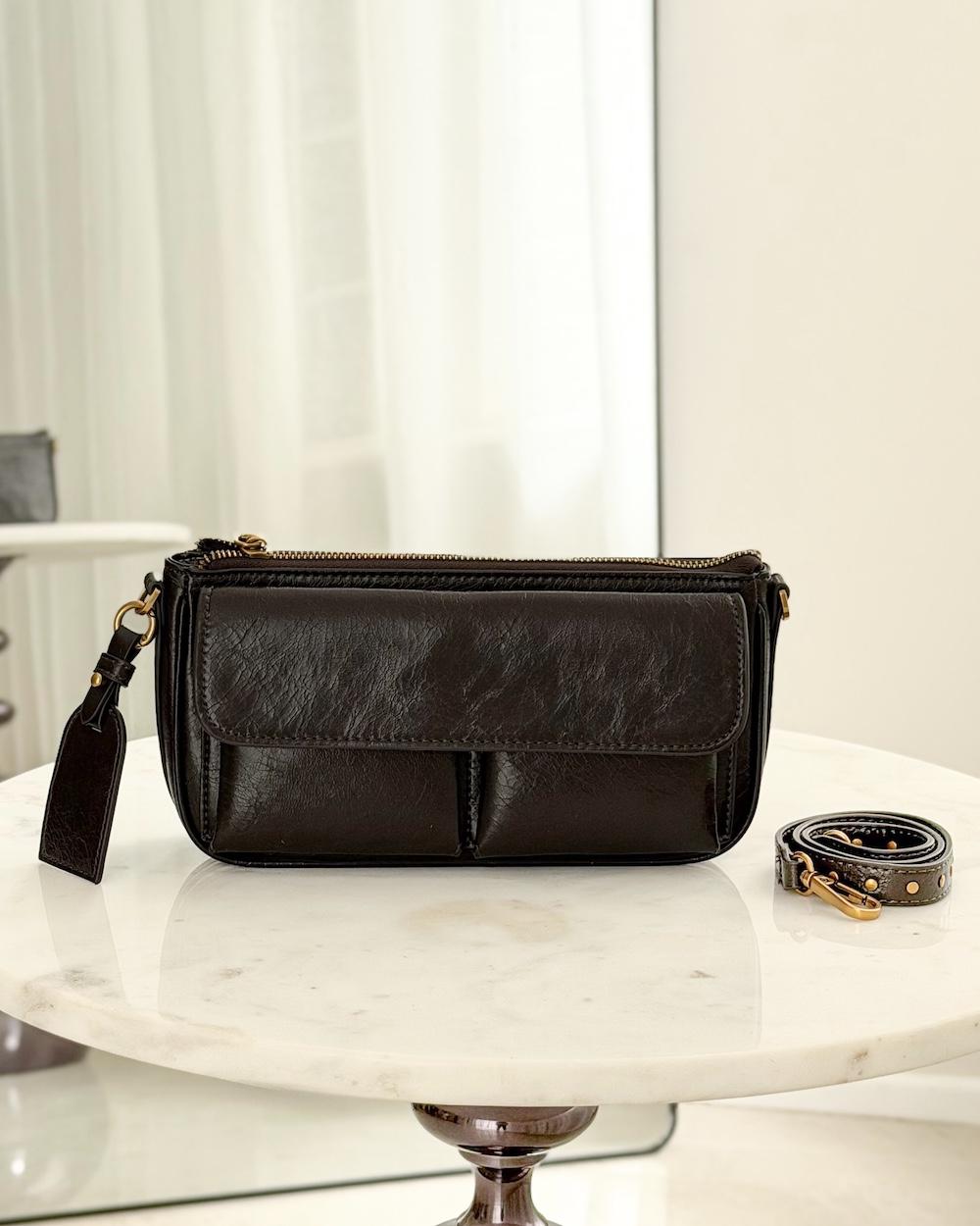 A soft handbag with a practical design and front pockets.