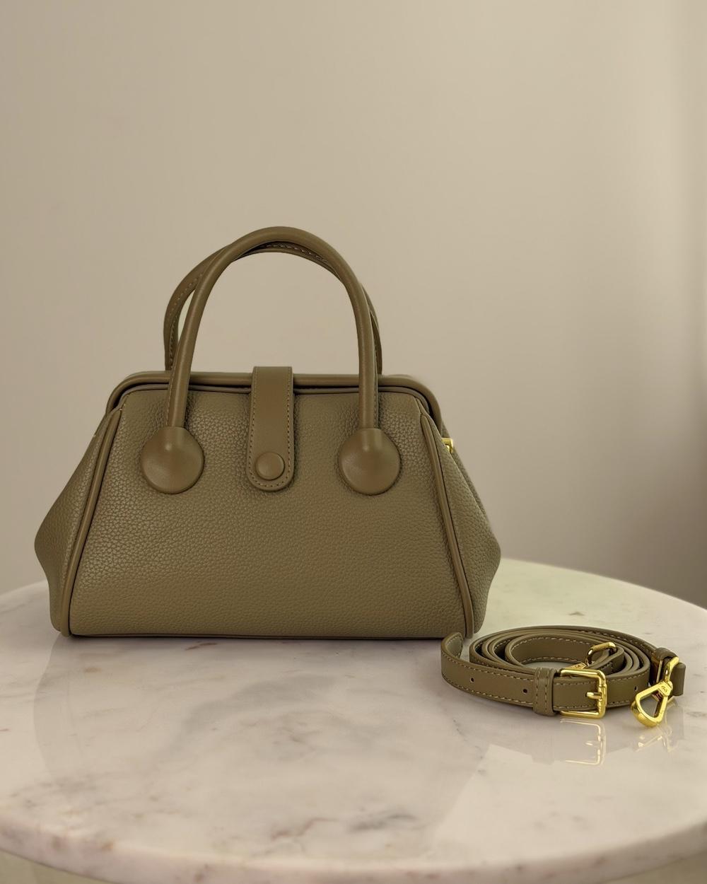 Handbag with a sleek design and stylish top handle