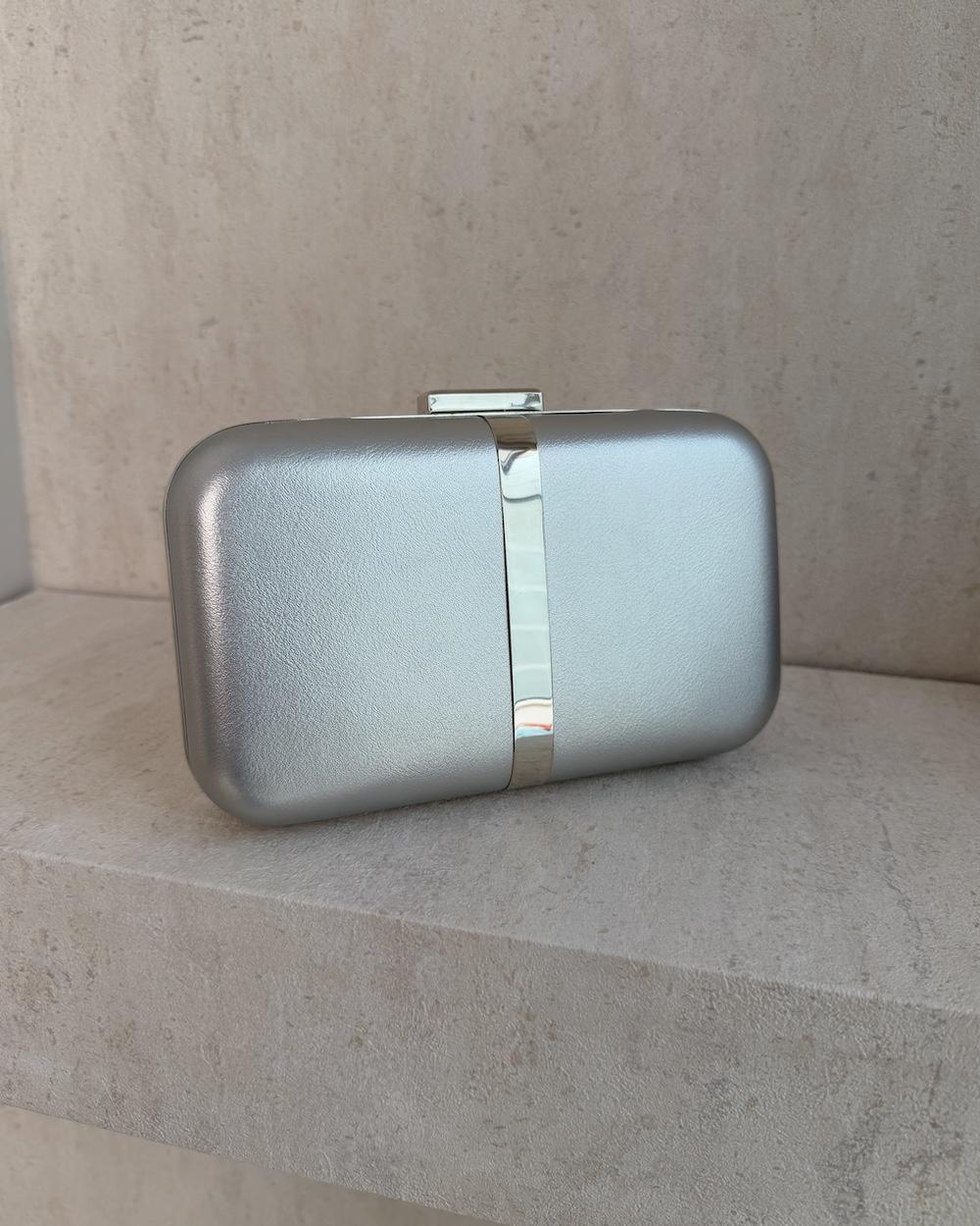 Evening bag decorated with a gold metal ribbon