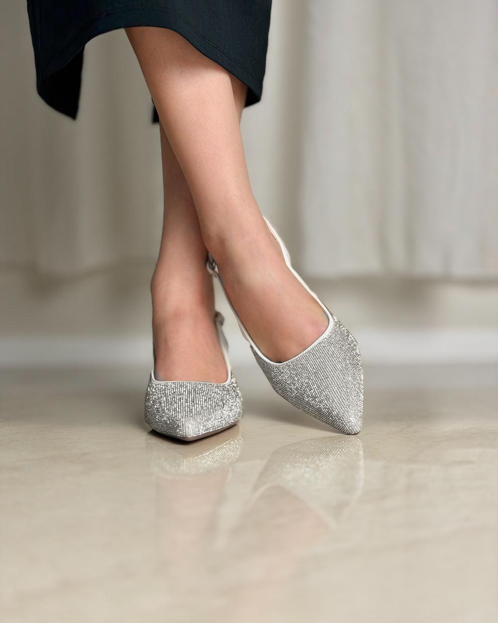 Elegant women's shoes with a thin heel and shiny details