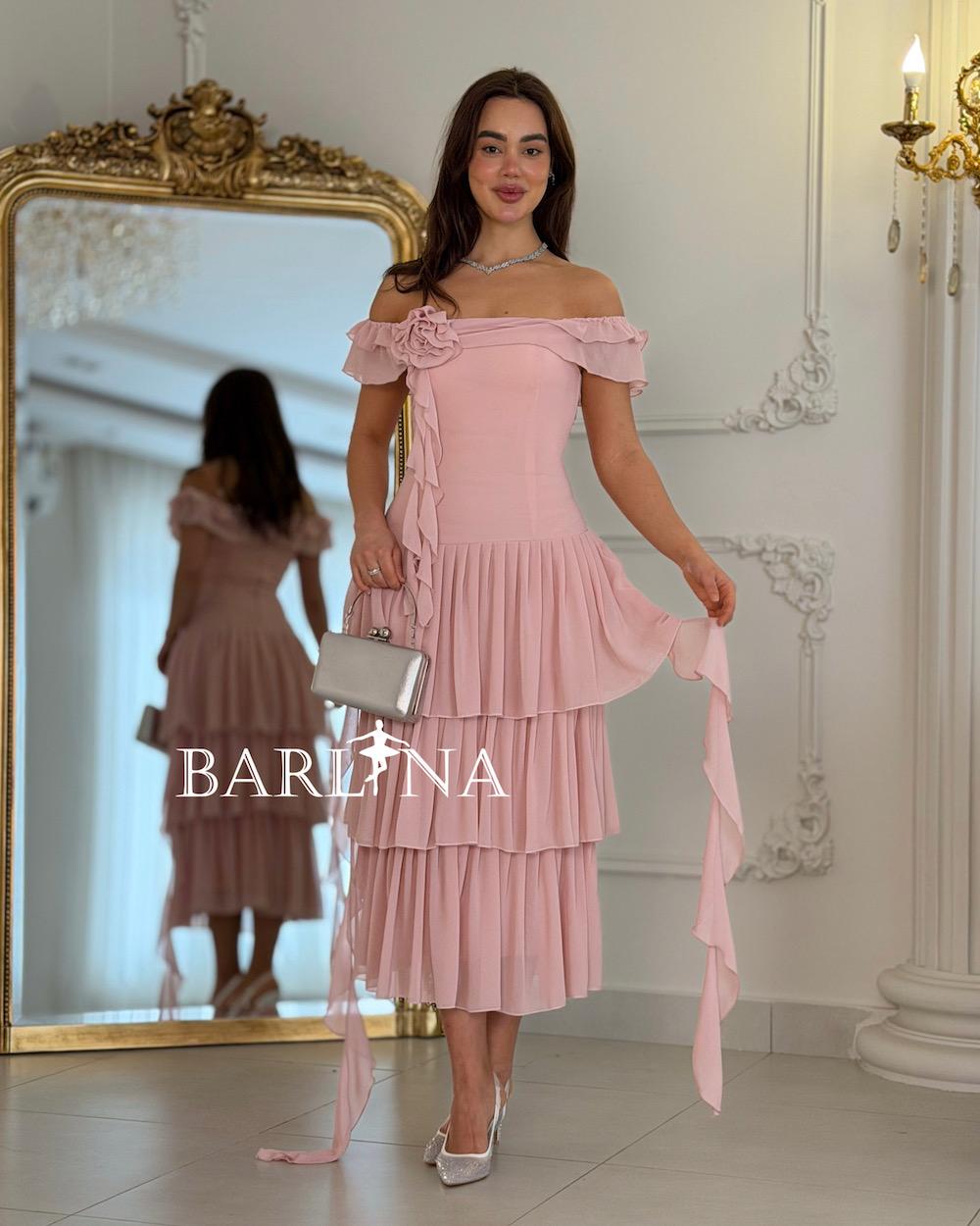 A soft, layered dress with a fabric rose.
