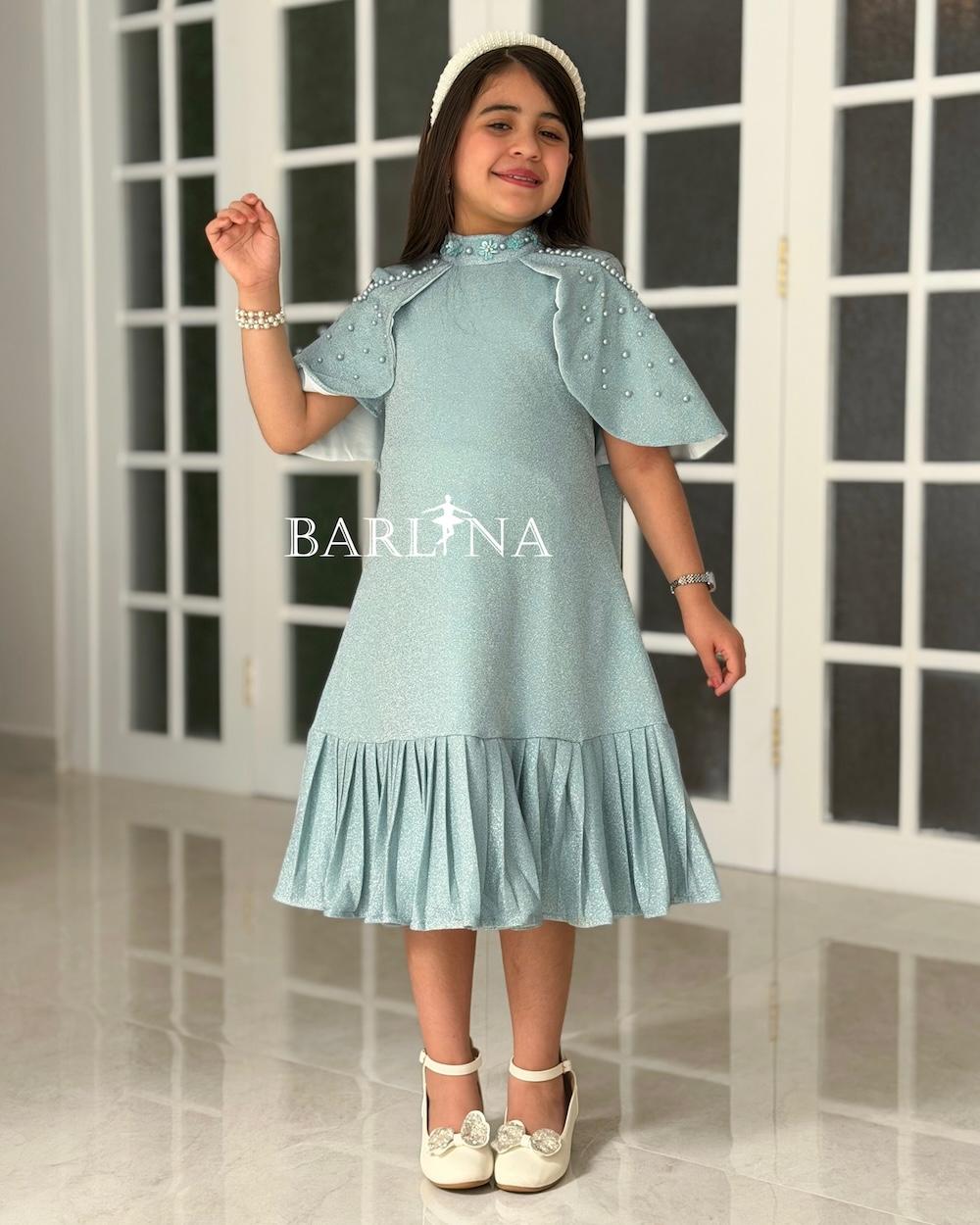 A shiny dress with a straight cut and a ruffled hem.