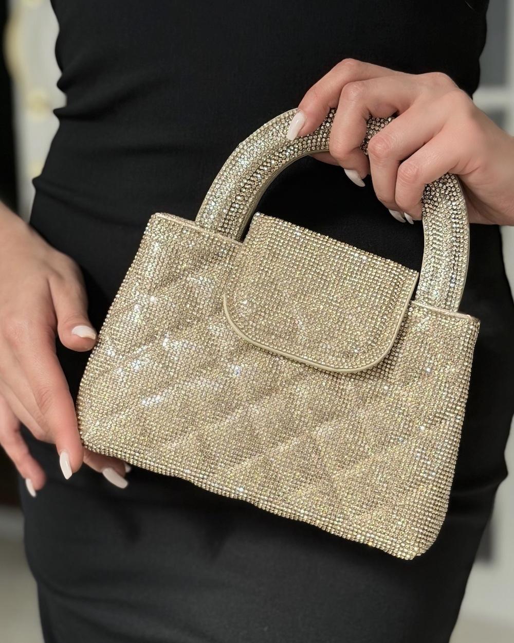A square-shaped handbag with a stylish wide handle.