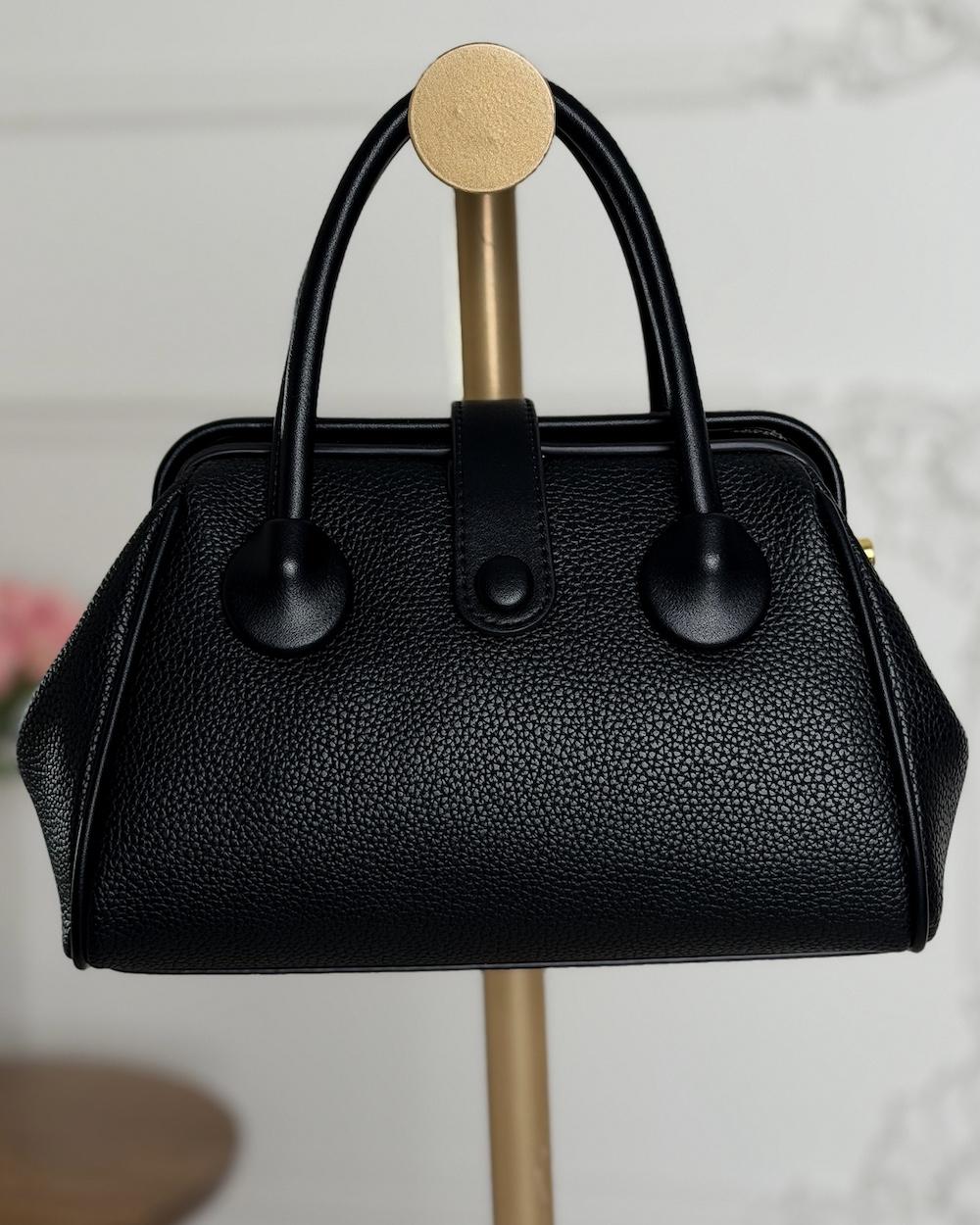 Handbag with a sleek design and stylish top handle