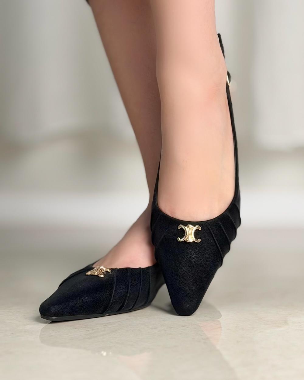Simple women's shoes adorned with a gold logo