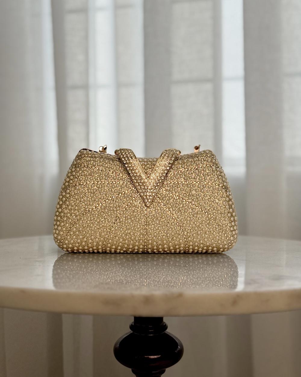 A luxurious occasion bag adorned with pearls and rhinestones