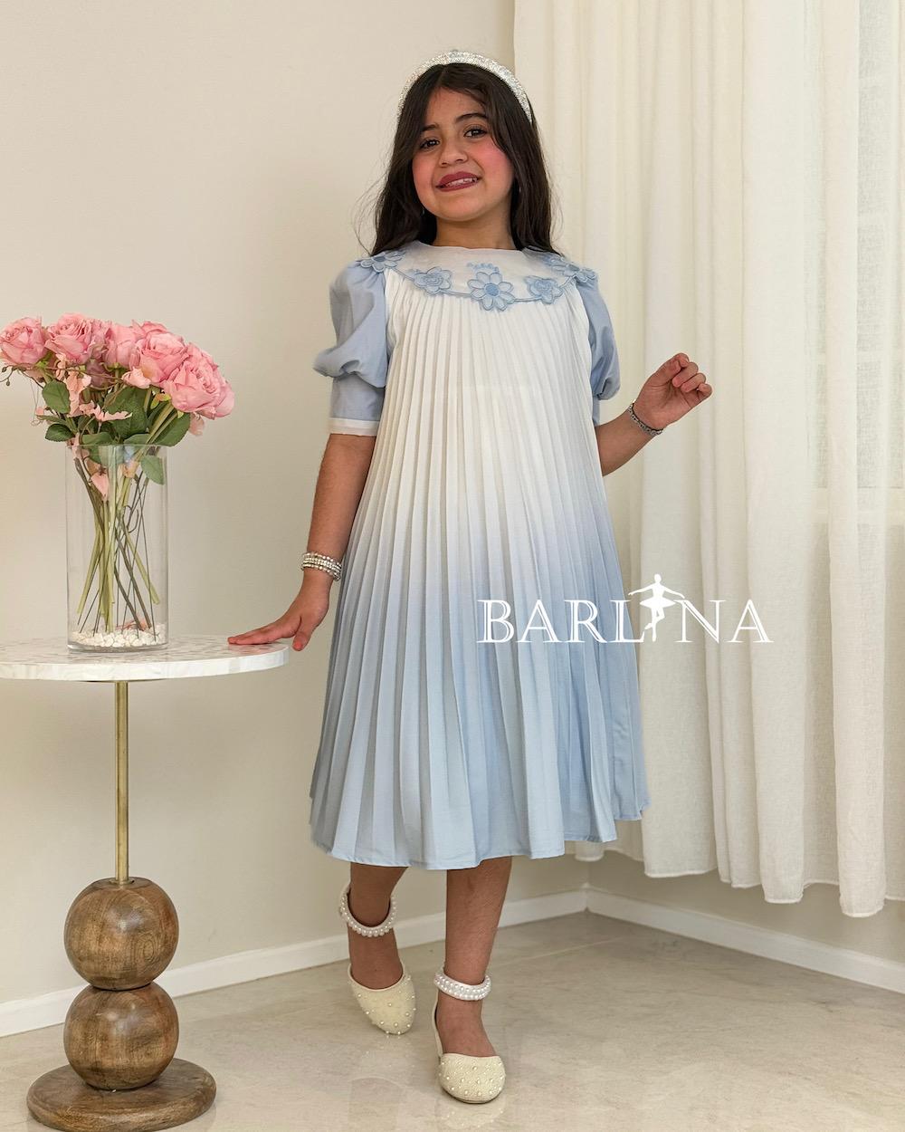 A soft, pleated girl's dress with embroidered flowers