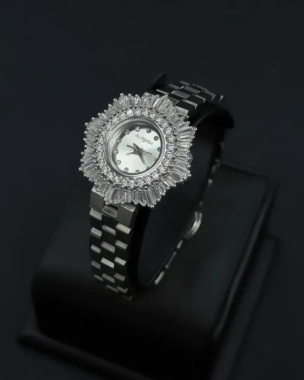 Elegant women's watch with a round studded bezel