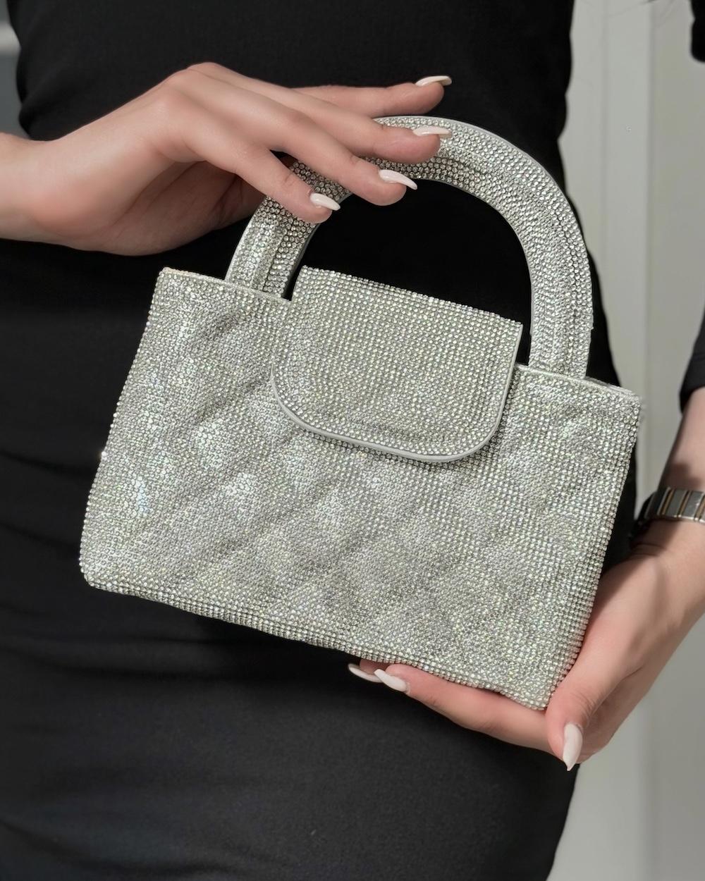 A square-shaped handbag with a stylish wide handle.