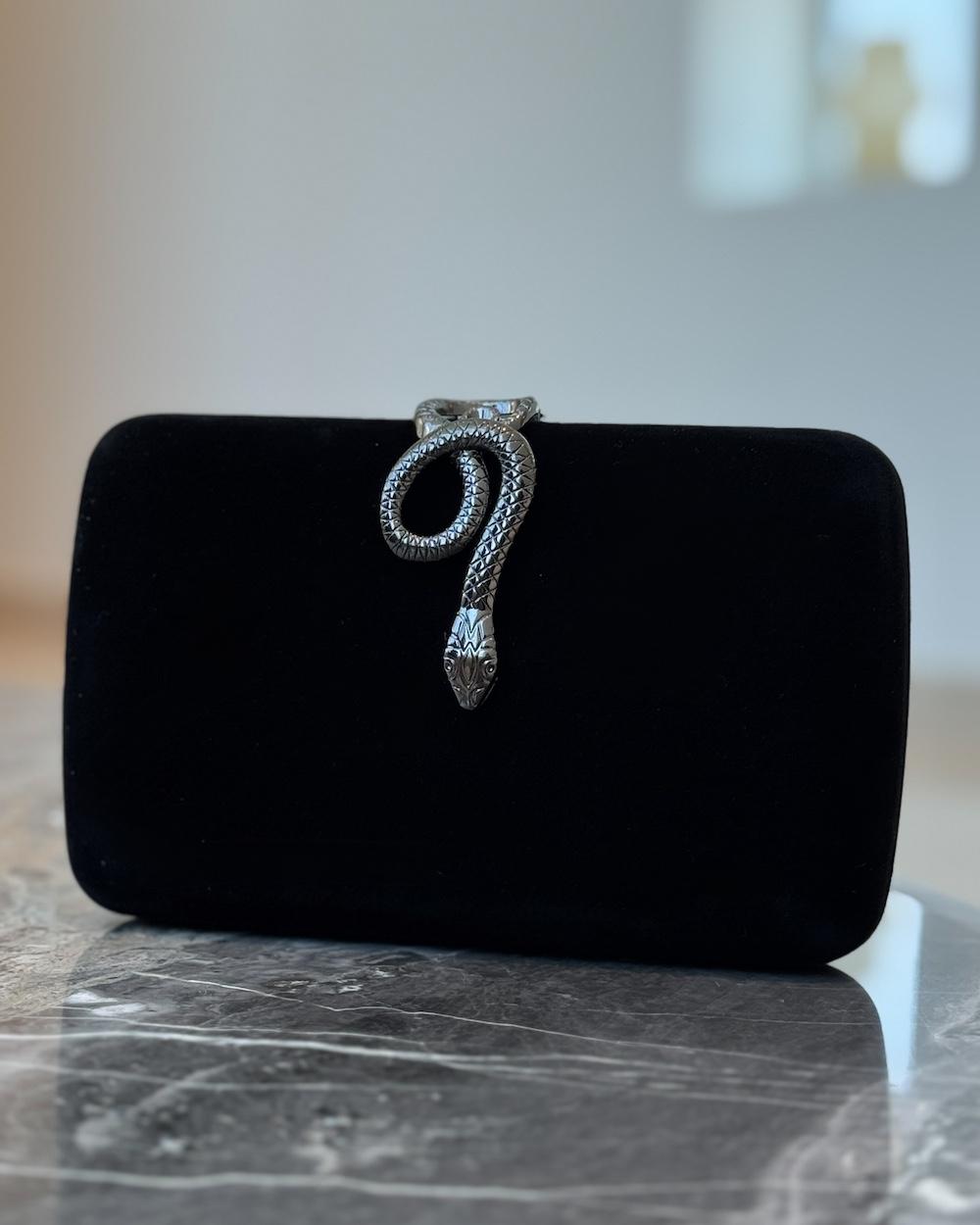 Clutch bag with metal snake lock
