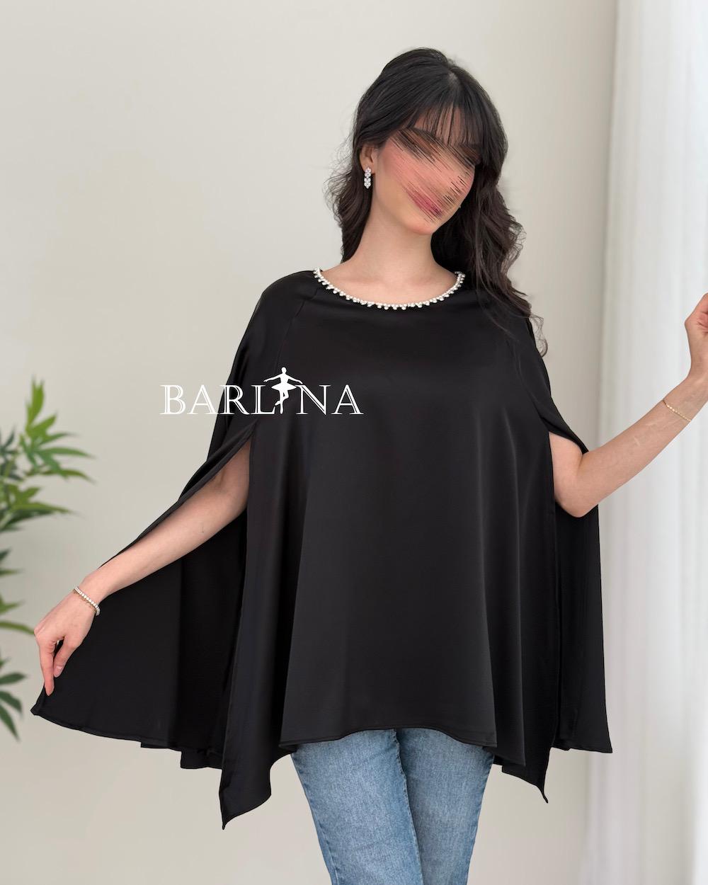 A soft blouse adorned with a pearl trim
