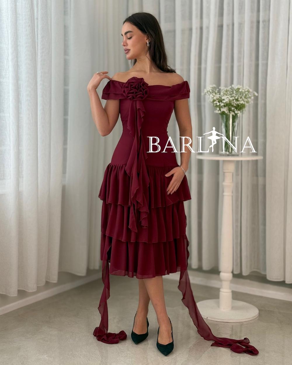 A soft, layered dress with a fabric rose.