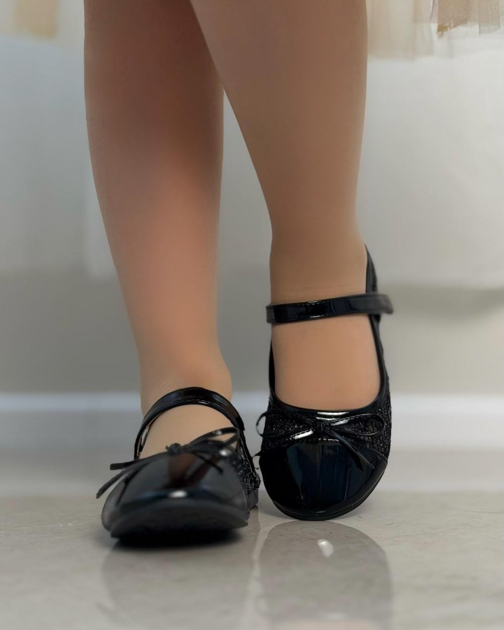 Girls' shoes with a front strap and a lace-up detail