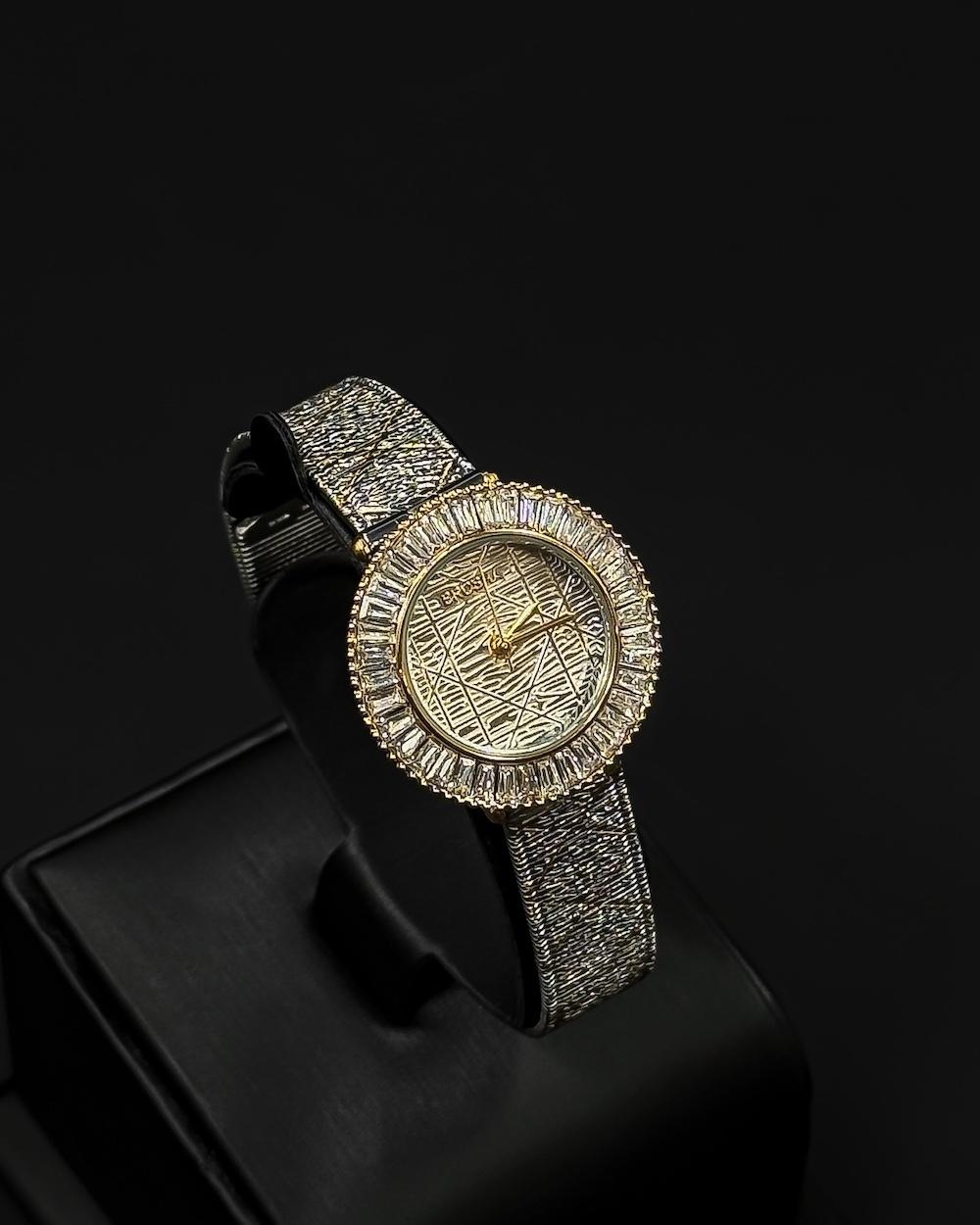 A women's watch adorned with a frame and engraved details