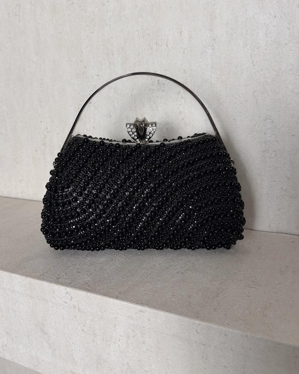 An evening bag adorned with matching pearls