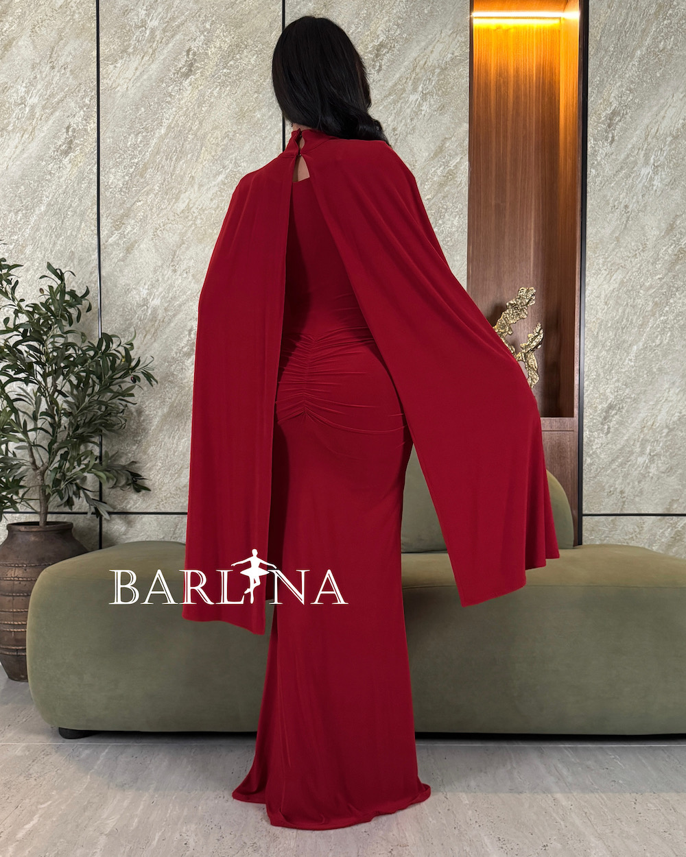 Burgundy dress with cape sleeves that fall from the shoulder