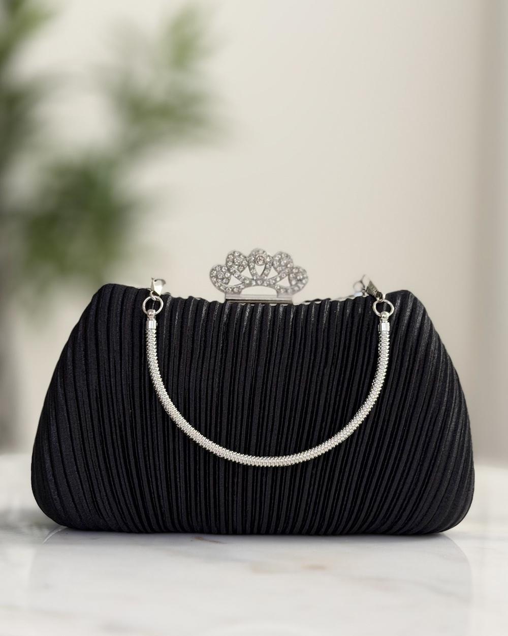 Handbag decorated with a crown-shaped top closure