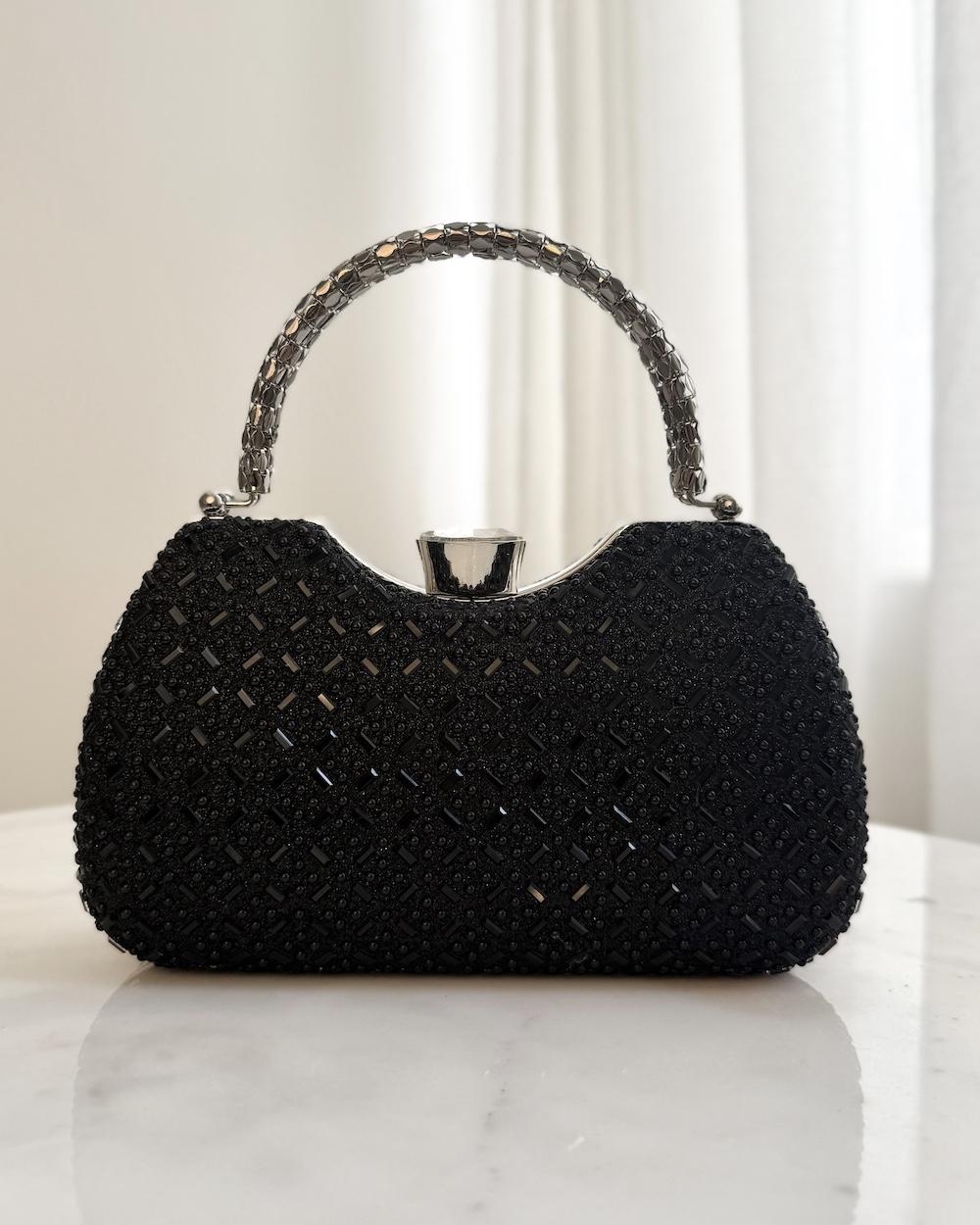 Luxury evening bag with interlocking metal handle