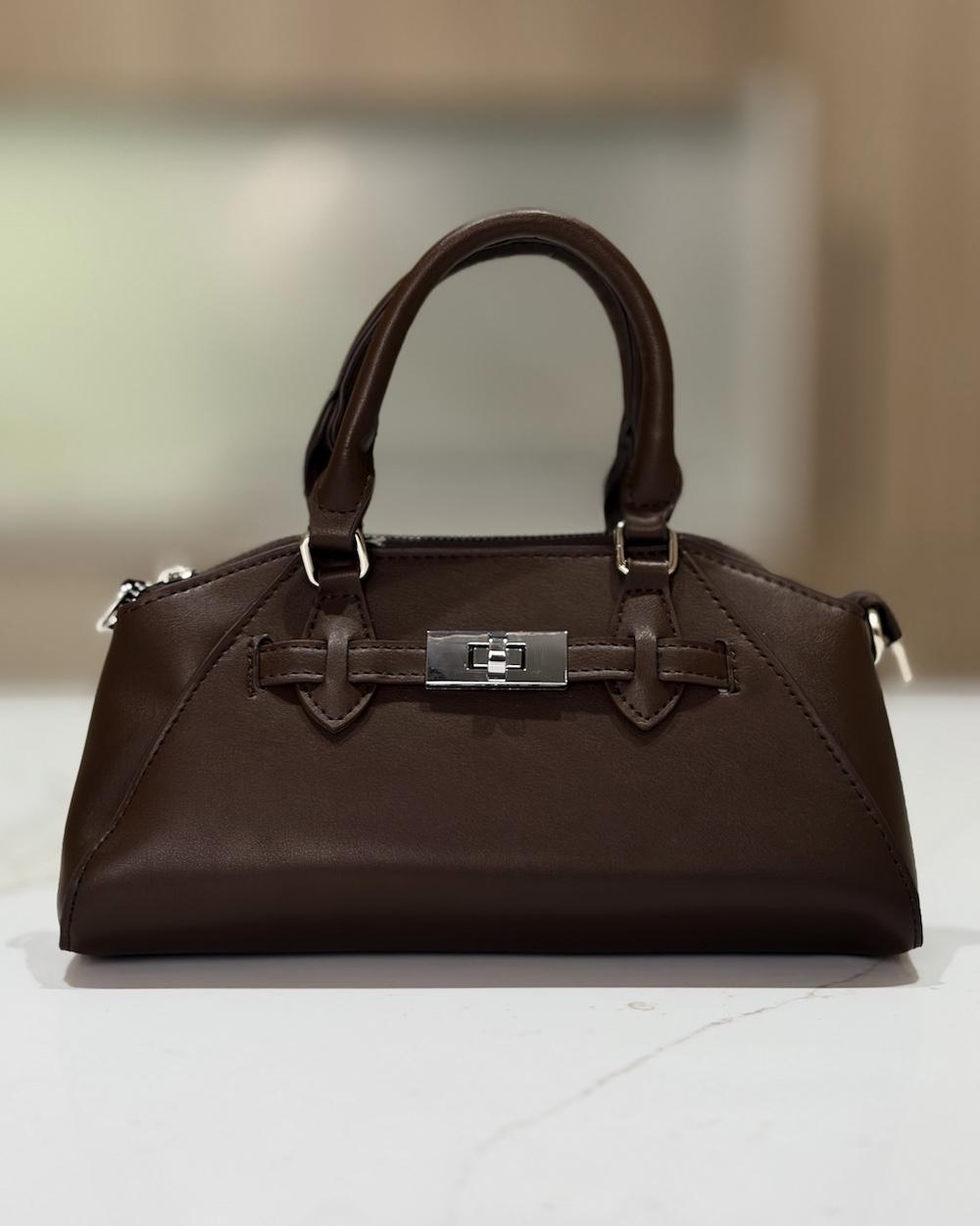A handbag with a luxurious classic design and a metal clasp.