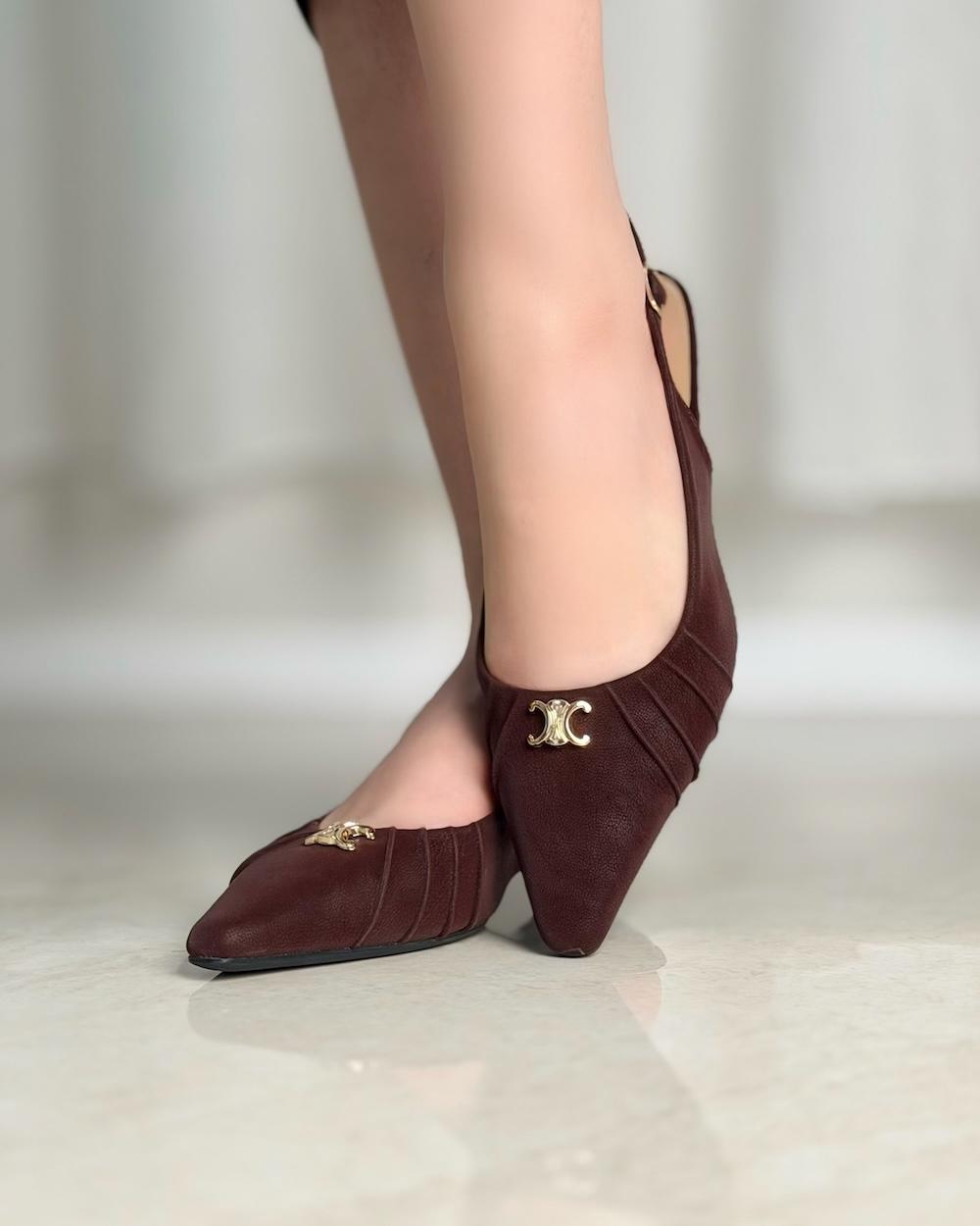 Simple women's shoes adorned with a gold logo