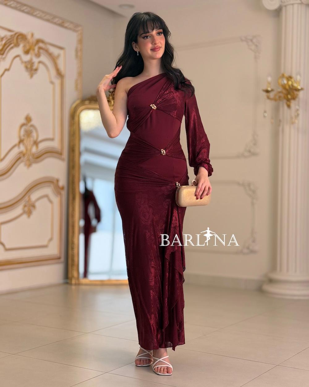 A soft, fitted dress adorned with elegant metallic details.
