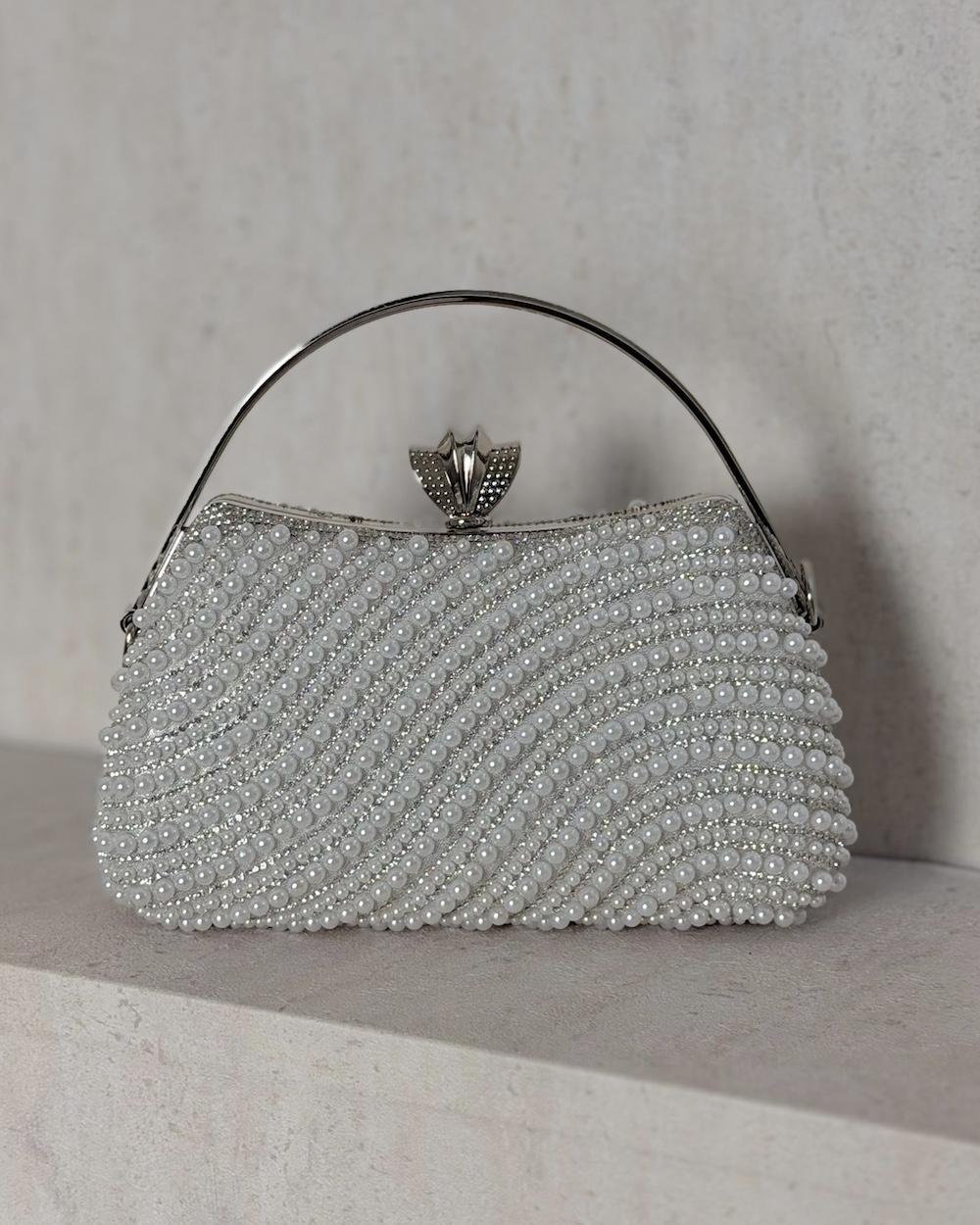 An evening bag adorned with matching pearls