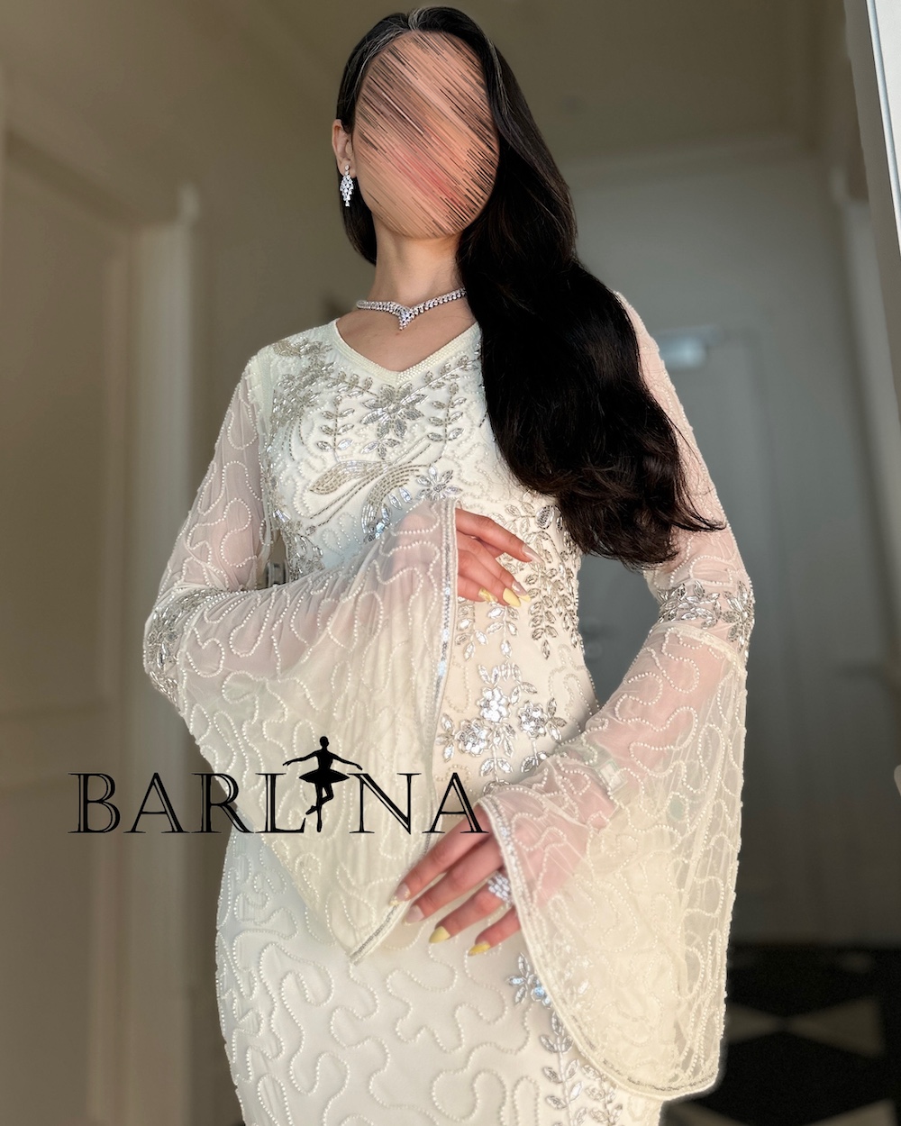 Ivory dress embellished with beads and wide sleeves