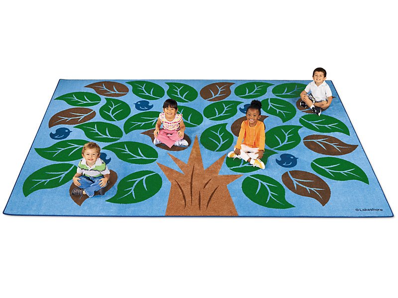 Children sitting around tree on nature mat