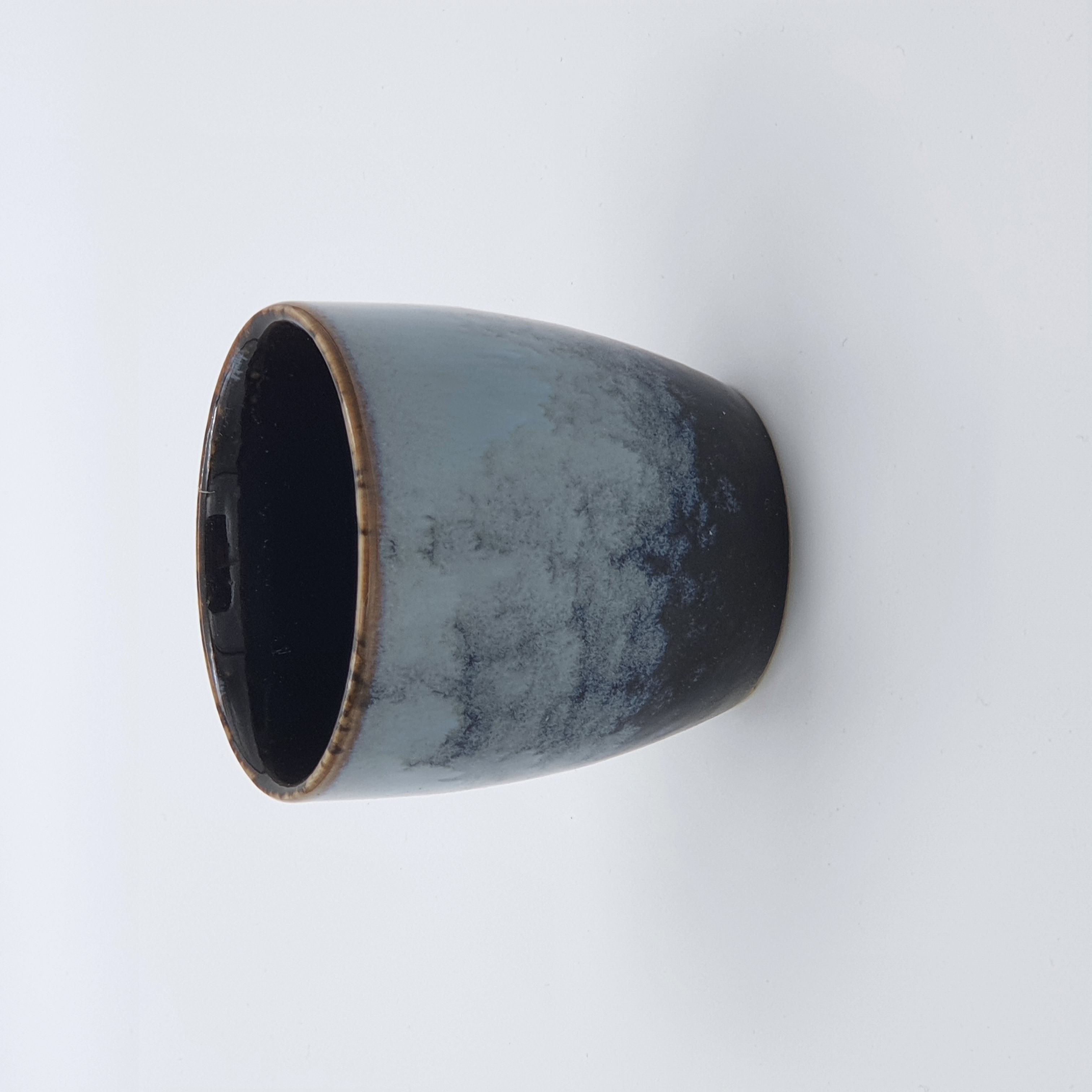 Small ceramic cup reflecting cultured taste