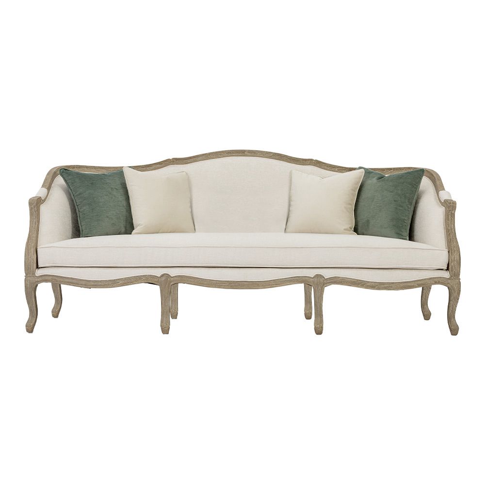 Classic sofa with a light wood frame and a white seat decorated with three cushions two green and one white