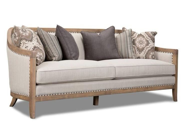 Threeseater sofa with beige upholstery and patterned cushions with a wooden frame