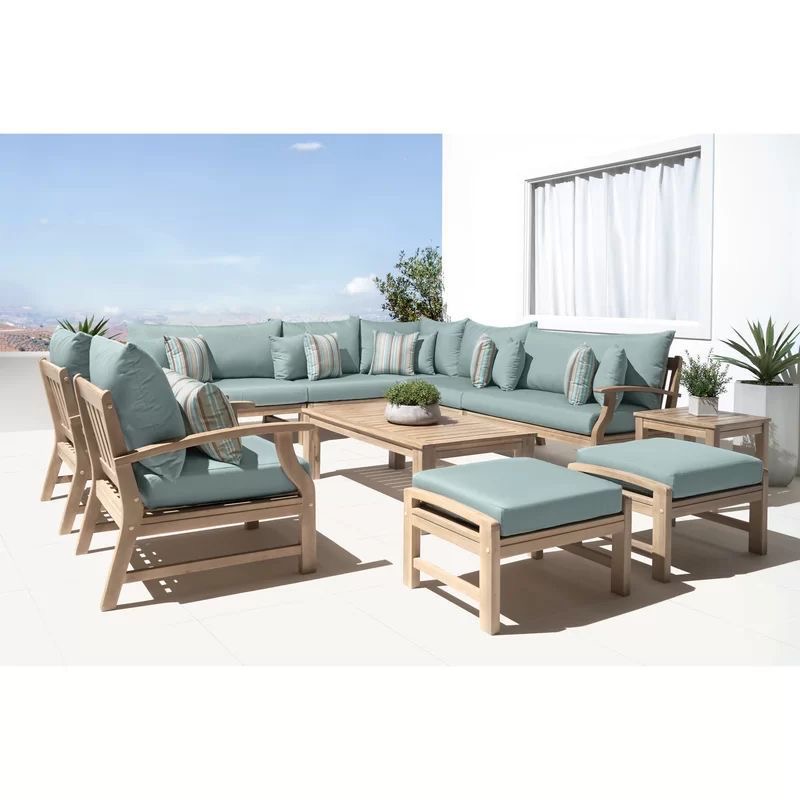 Full outdoor seating set of a corner sofa two single chairs two small puffs and a wooden coffee table