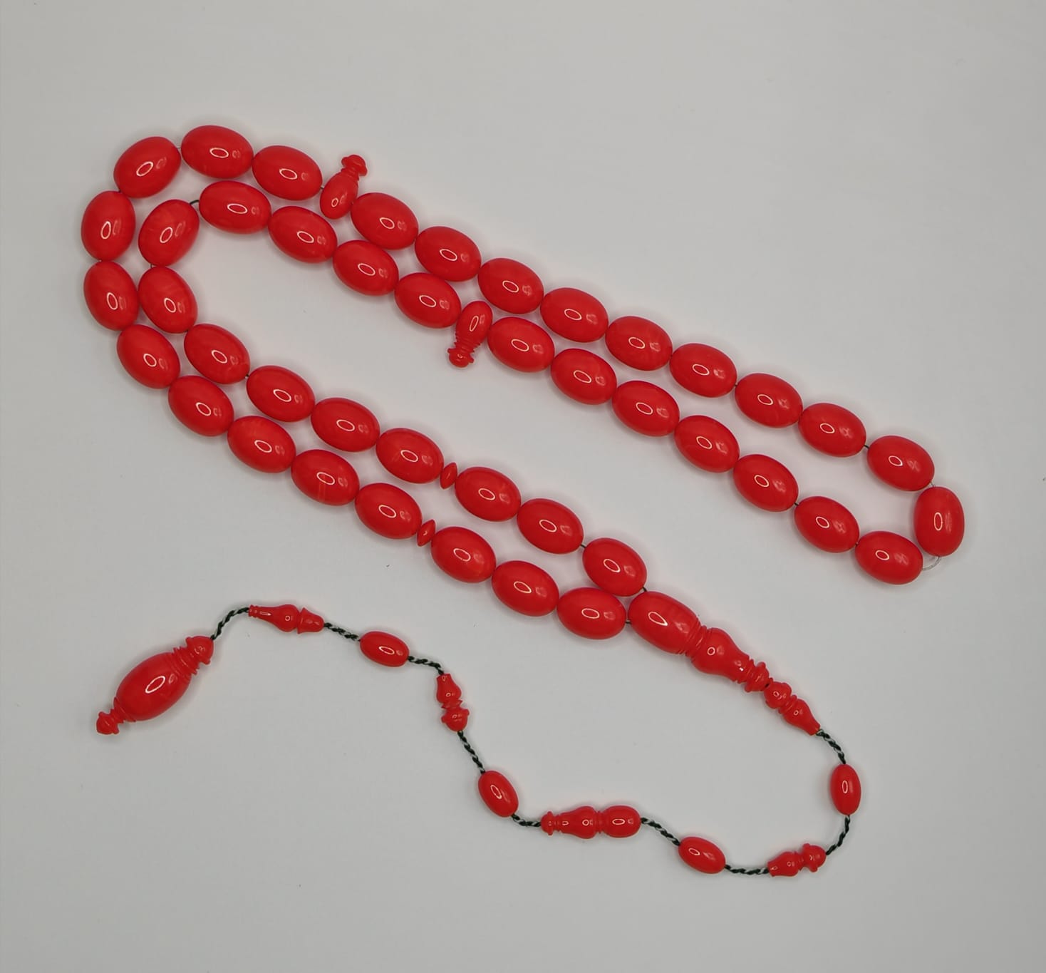 Vintage cast Bakelite Afyash misbaha with 43 red pigeon egg shaped beads.