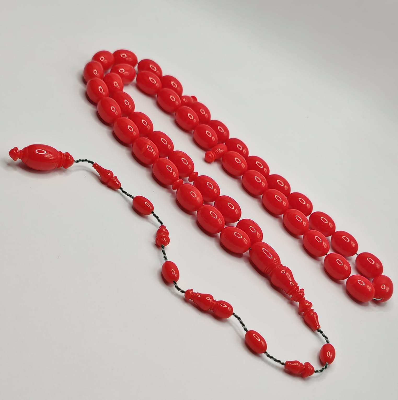 Vintage cast Bakelite Afyash misbaha with 43 red pigeon egg shaped beads.
