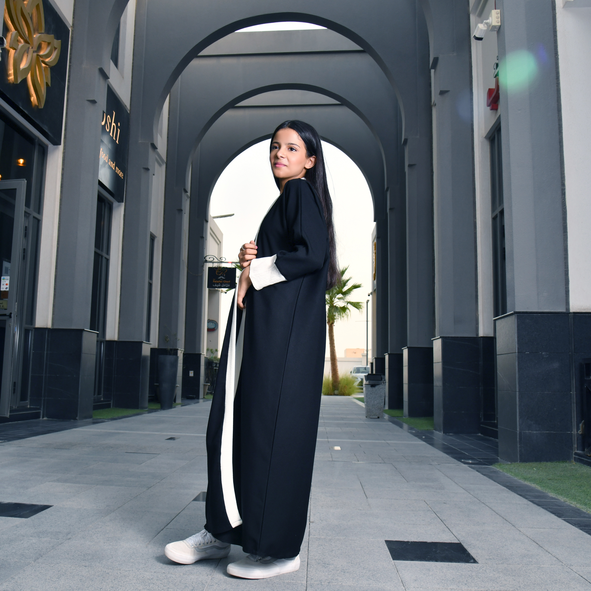  عباية لف بناتية باللون الأسود مع تحديد الأبيض على الحواف والأكمام 