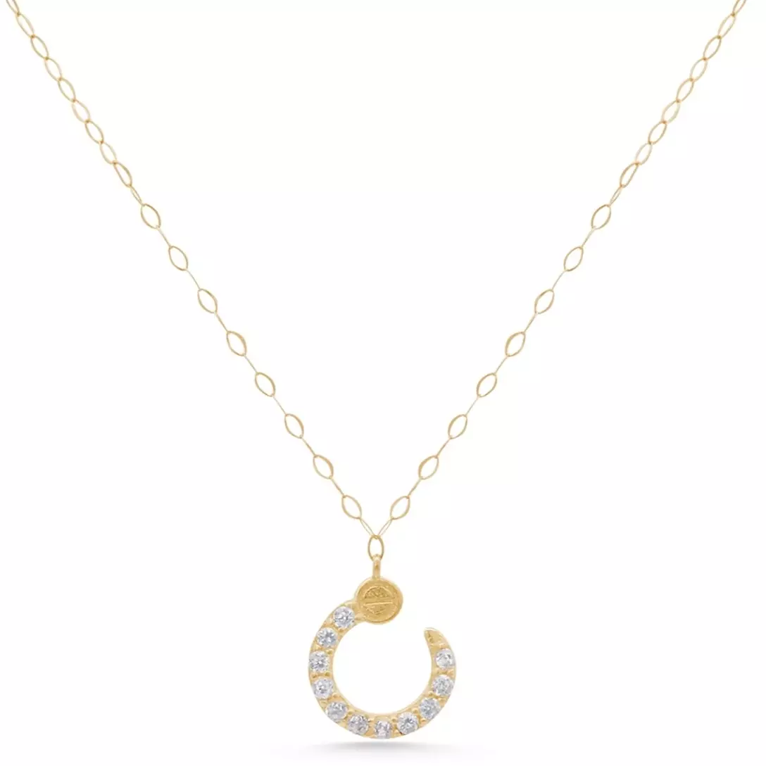 Delicate gold necklace with a shiny crescent