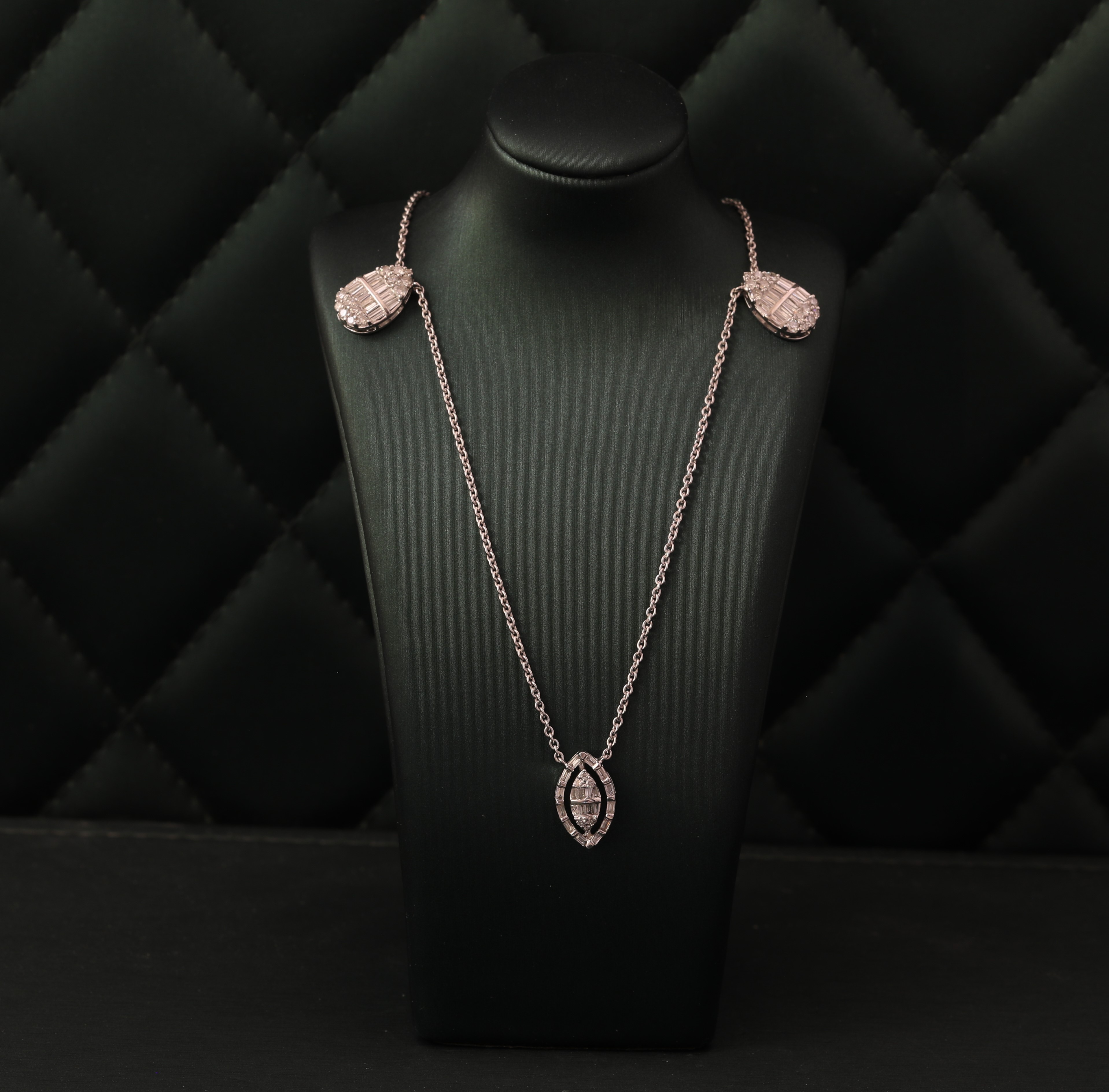 Diamond pendant with accents on a white gold chain