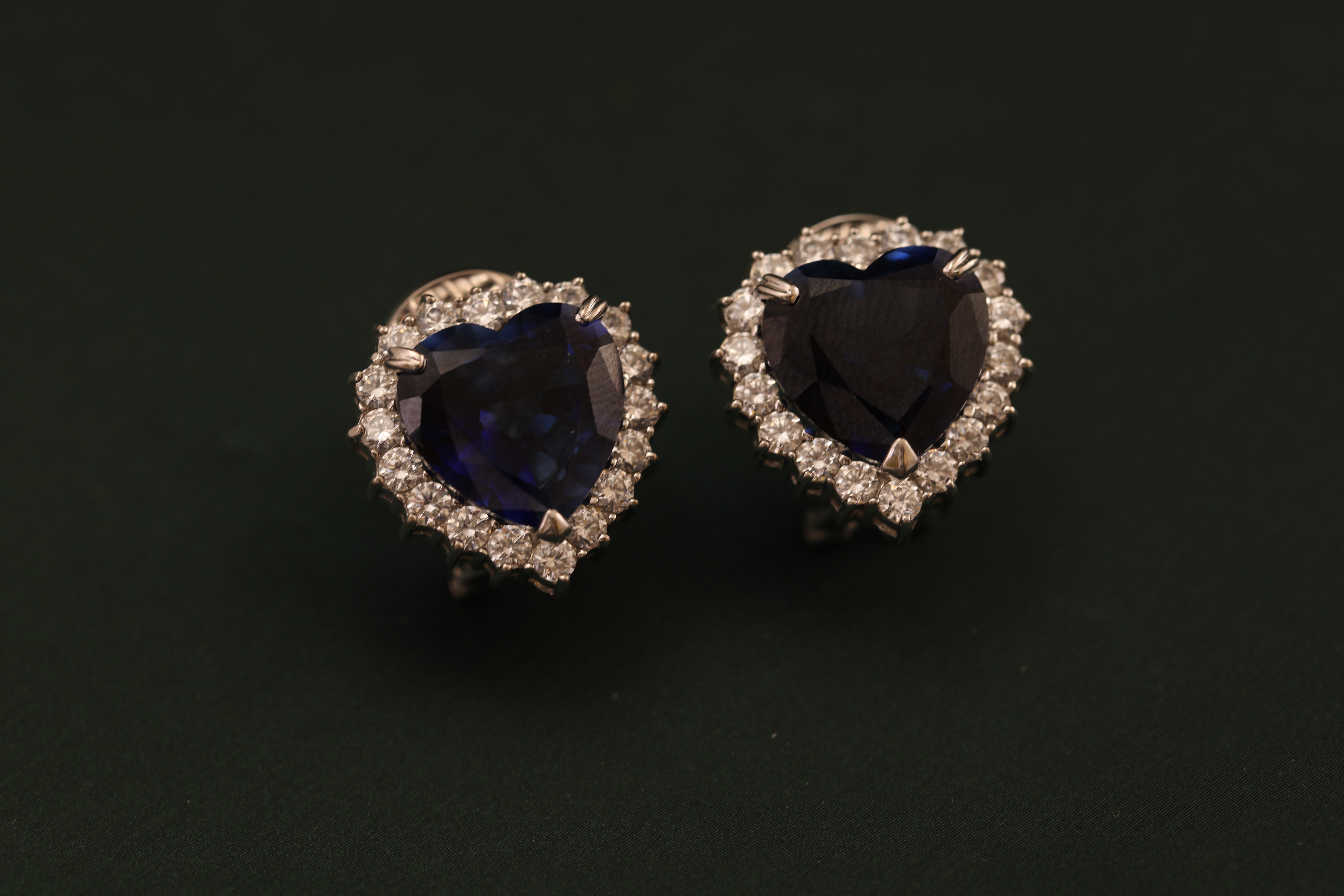 Dark blue heart-shaped stones surrounded by white gems
