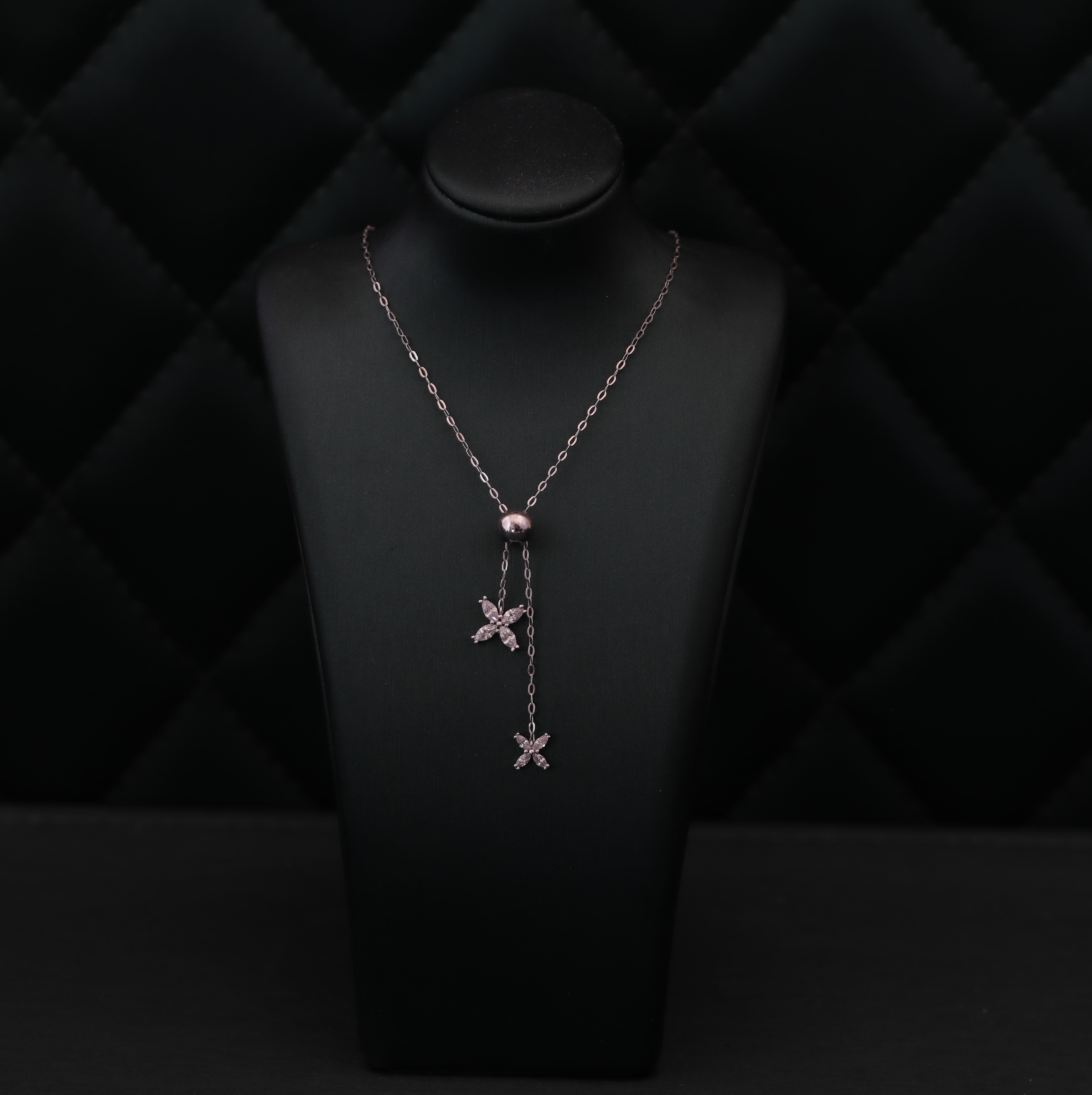 Silver necklace decorated with small ornaments