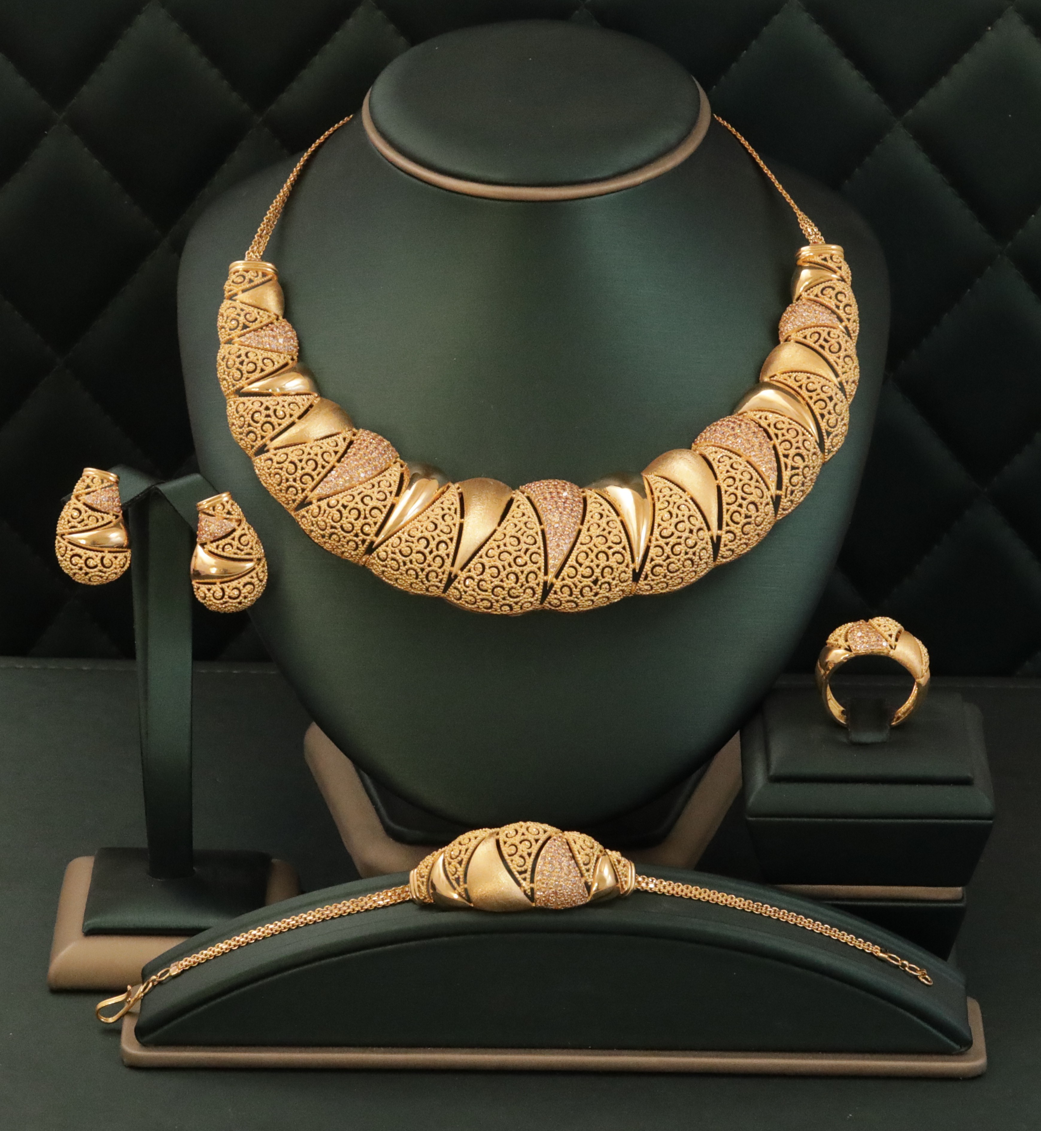 Elegant gold necklace and matching earrings on display