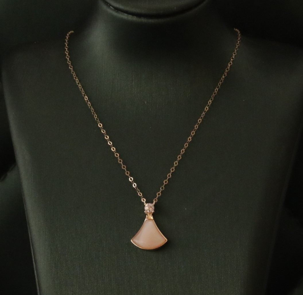 Gold necklace with pink gemstone charm