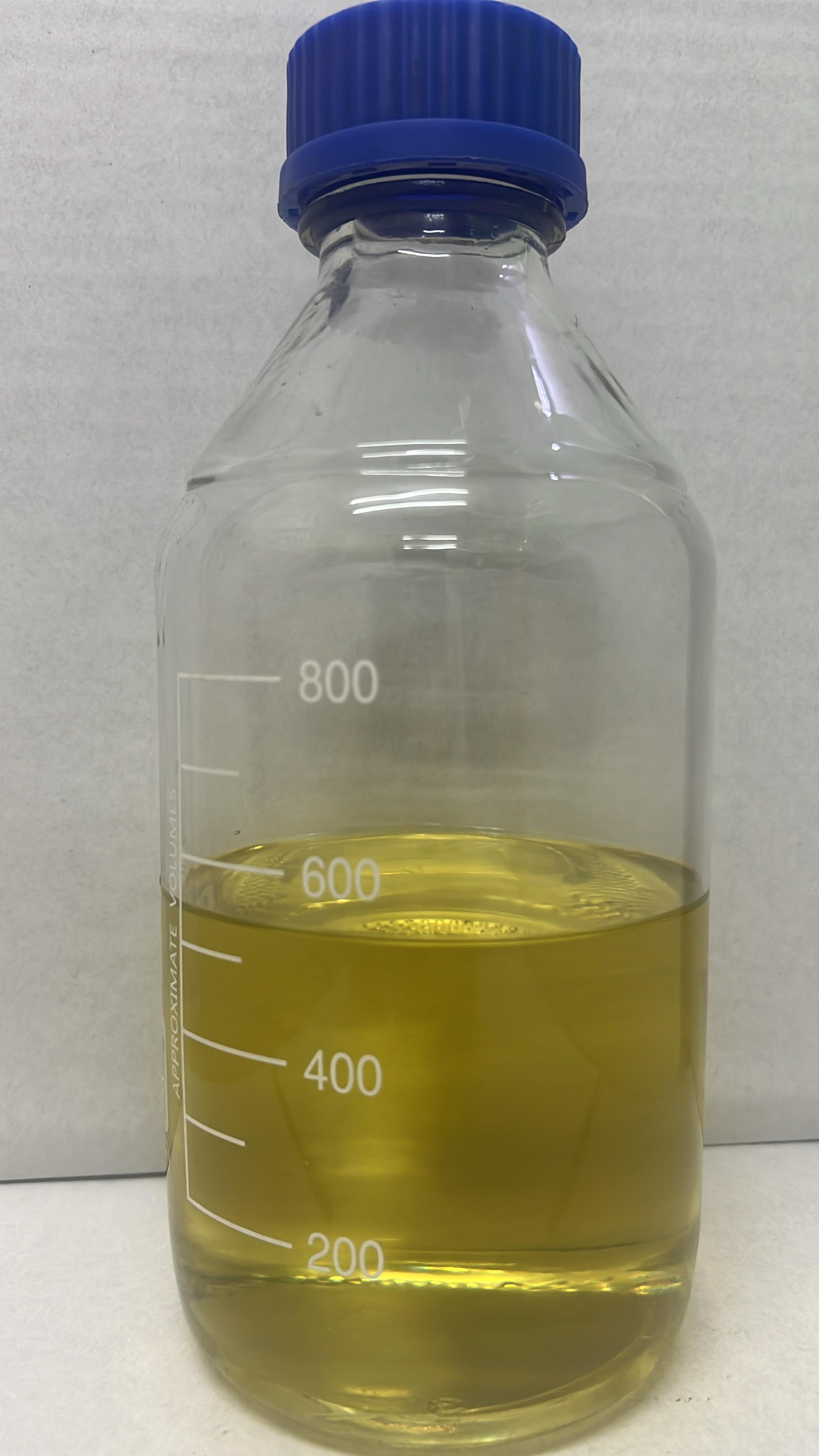 Essential oil in a transparent measuring bottle with a blue lid