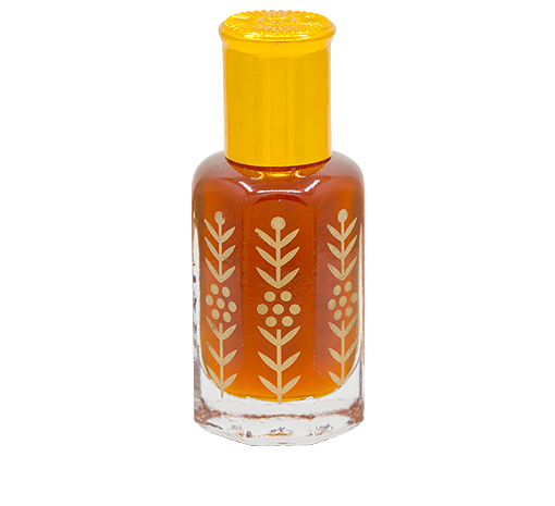 دهن العطر داخل زجاجة شفافة مزينة بنقوش ذهبية وغطاء ذهبي