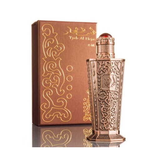 مشعل عطرجي طيب الحجاز 15 مل دهن علبة بنية مزخرفة بزخارف ذهبية وزجاجة دهن مزخرفة بنقوش ذهبية