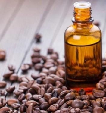حبوب قهوة متناثرة مع زيت عطري