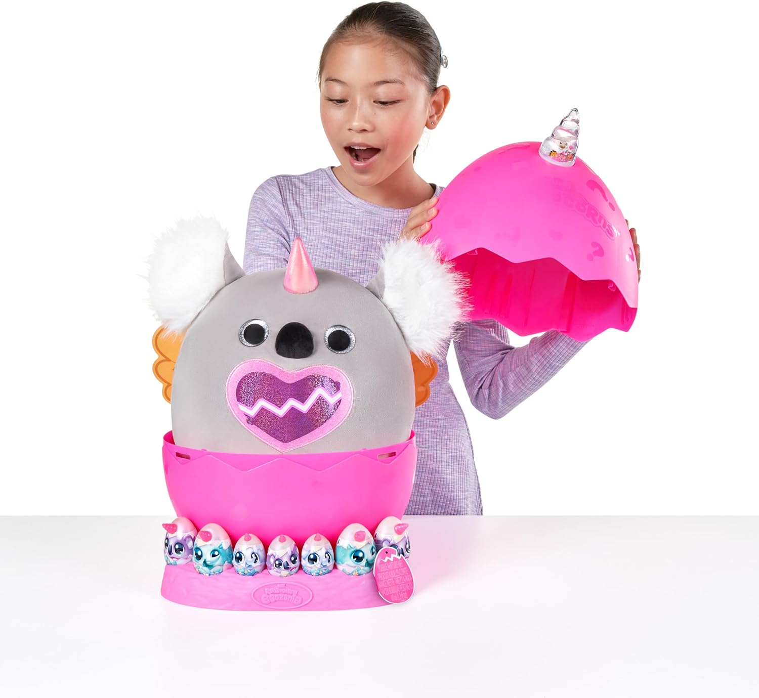 Girl holding a pink unicorn plush