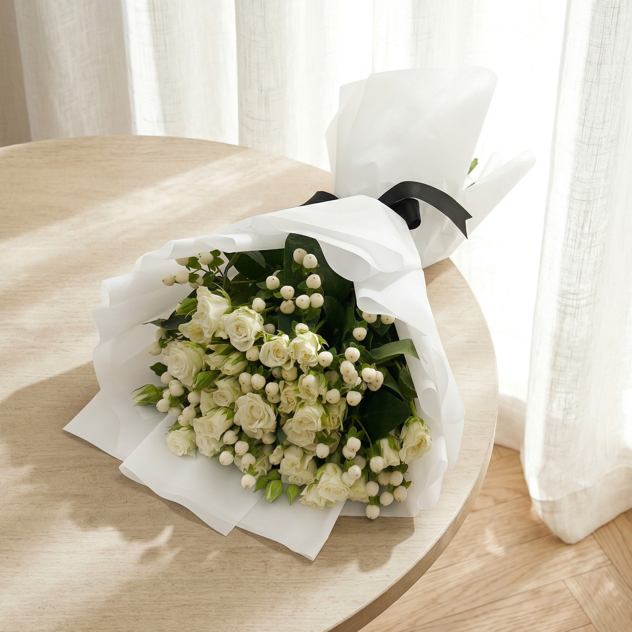 Peace and Love bouquet of white baby roses and hypericum with a black ribbon
