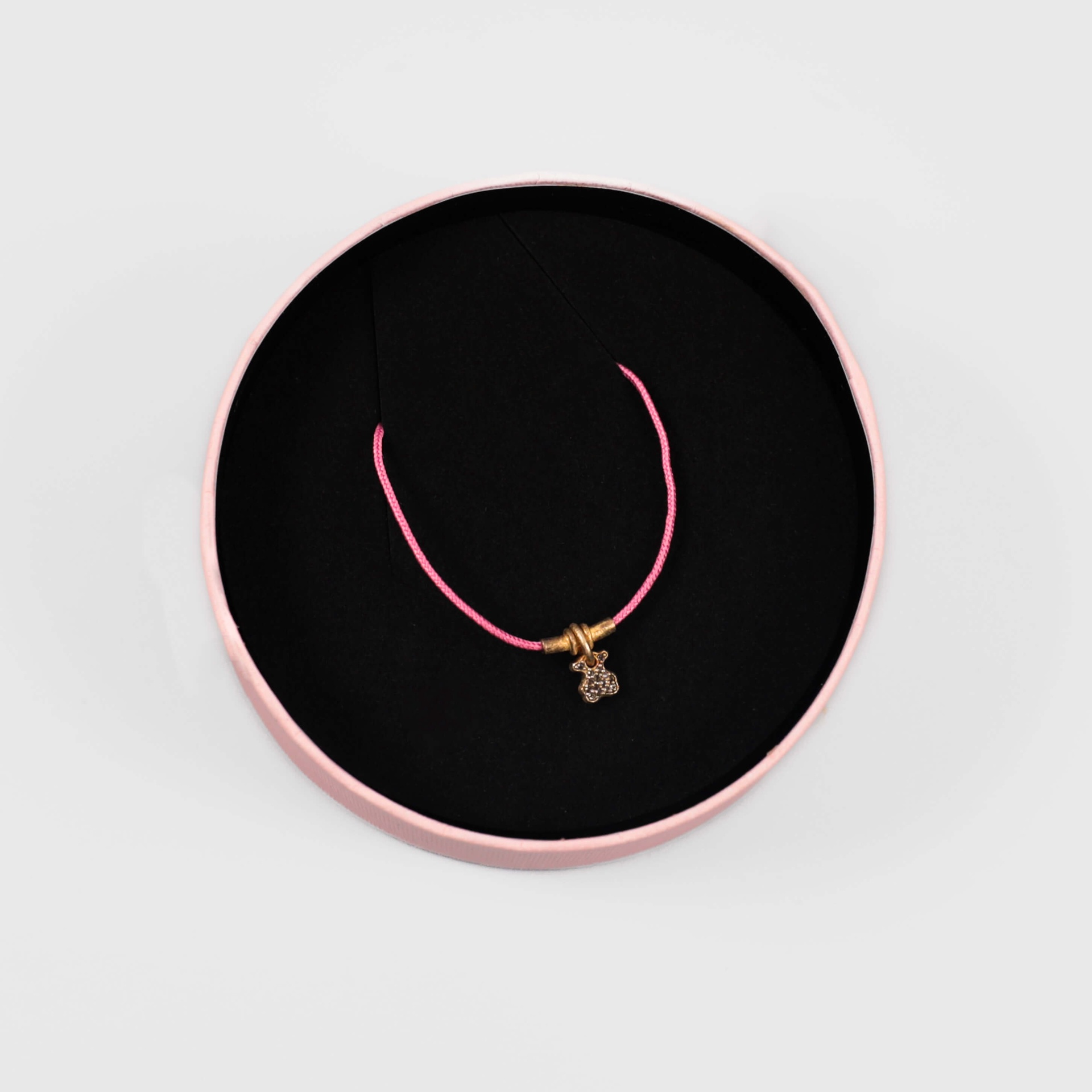 Tous gold teddy bear bracelet with a pink cord
