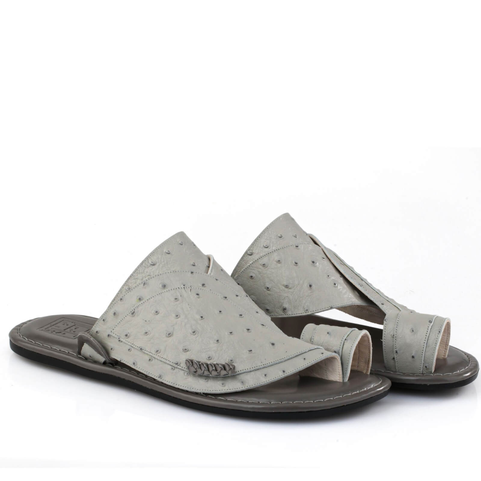 Stitching details and classic toe ring on a grey oriental sandal